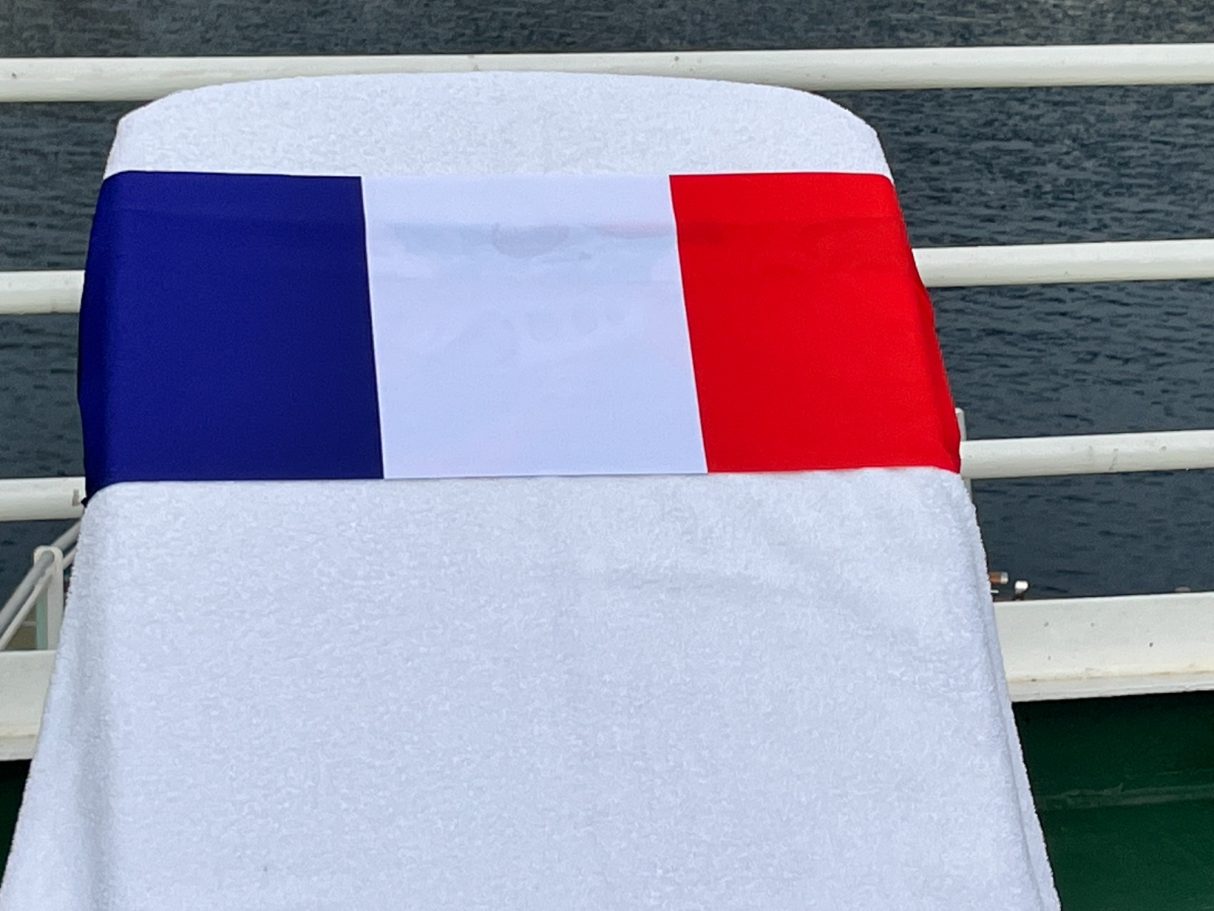 The french National flag holding a towel onto a sun lounger. see tcboo.shop