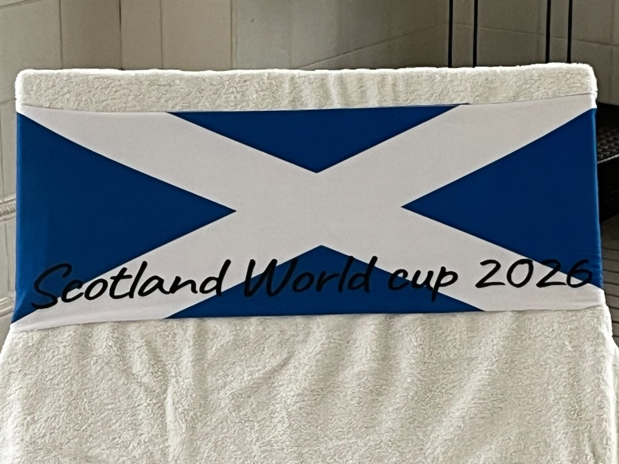 The National flag of Scotland holding a towel onto a sun lounger. see tcboo.shop