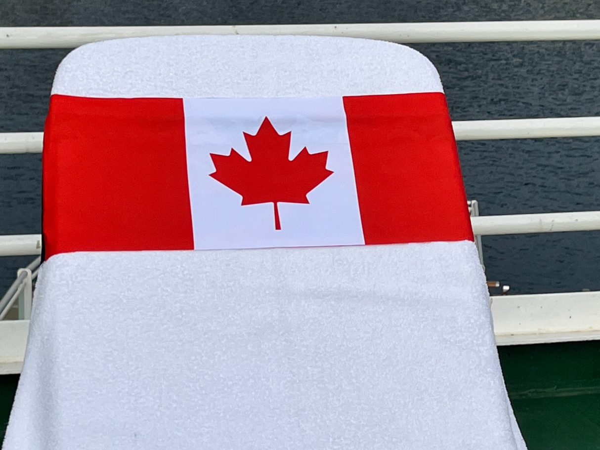 The Canadian flag holding a towel onto a sun lounger. see tcboo.shop