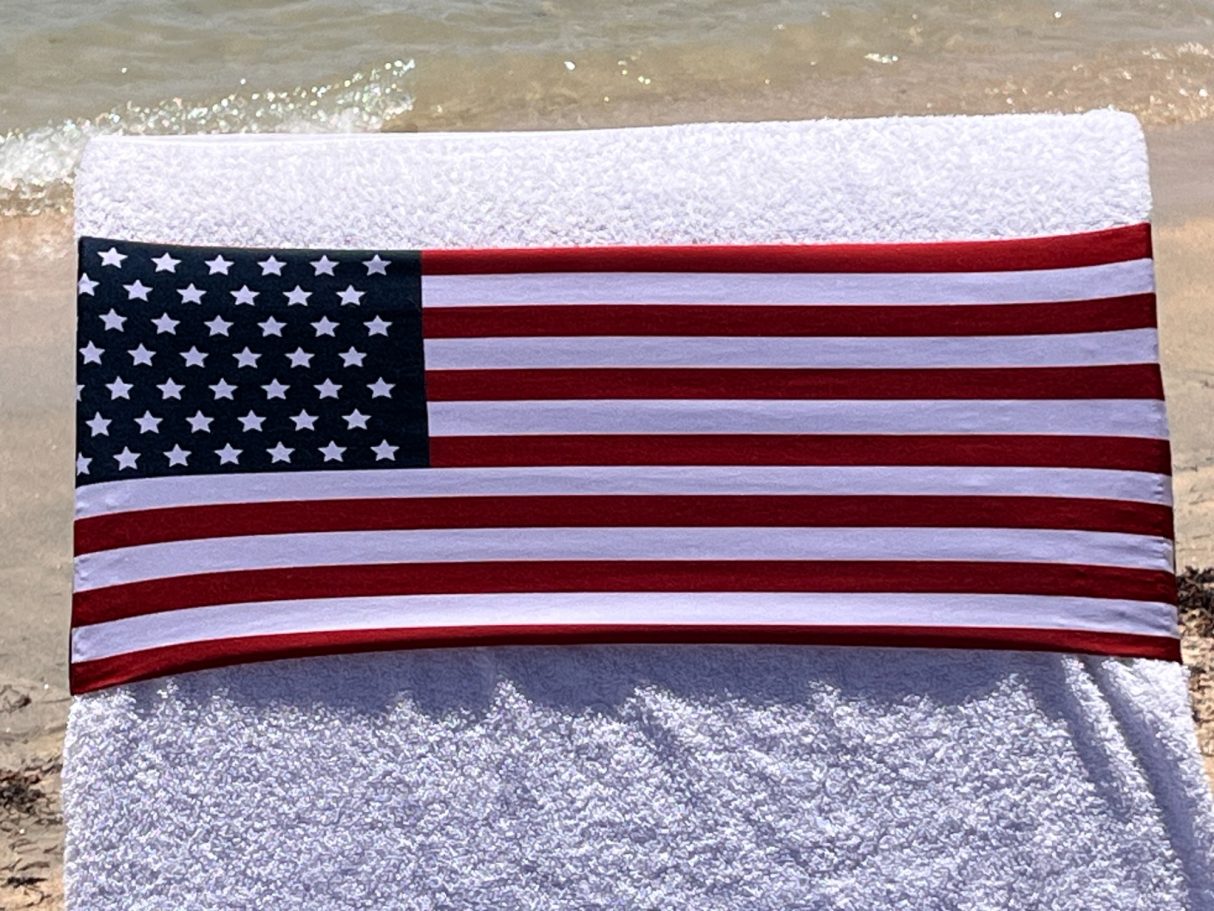the American flag holding a towel onto a sun lounger. see tcboo.shop