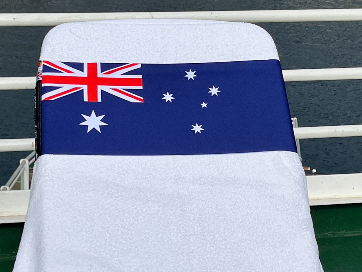 An Australian National flag holding a towel onto a sun lounger. see tcboo.shop